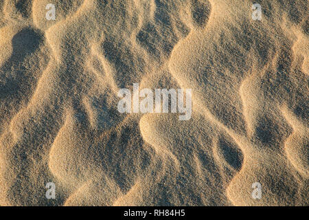 DRY BEACH SAND IN SOFT EVENING LIGHT SHOWING TEXTURE CREATED BY MOVEMENT OF THE SEA Stock Photo