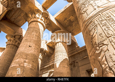 Pillars at the temple of Kom Ombo, decorated with hieroglyphics. The blue sky is seen through the ceiling, Egypt, October 23, 2018 Stock Photo