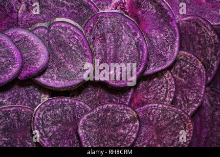 Purple potatoes sliced background in full frame Stock Photo