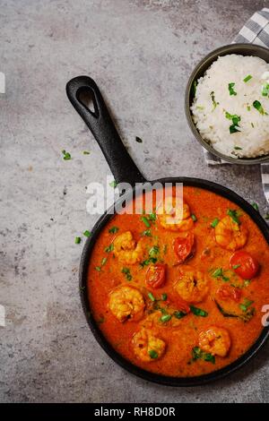 Shrimp in curry coconut sauce with rice in a bowl - Curried prawns,  overhead view Stock Photo