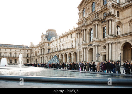 PARIS, FRANCE - January 4, 2012: People waiting in a queue to visit the Louvre Museum Stock Photo