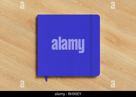 Blue square notebook with elastic band on white background Stock Photo ...