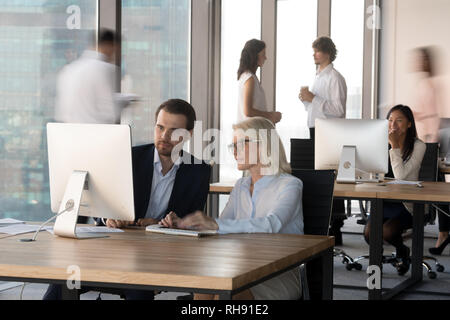 Executive managers working together with computer in modern corporate office Stock Photo