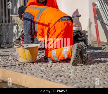 worker laying in pebble floor Stock Photo