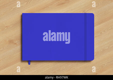 Blue horizontal notebook with elastic band on wooden background Stock Photo