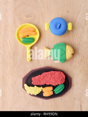 View of miniature toy food on wood background. Top view. Flat lay. Stock Photo