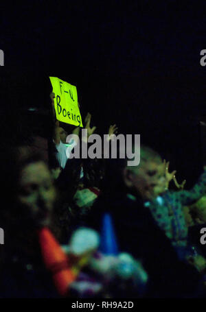 A man holds a sign expressing his displeasure with Boeing during the Order of the Polka Dots Mardi Gras parade in Mobile, Alabama, Feb. 24, 2011. Stock Photo