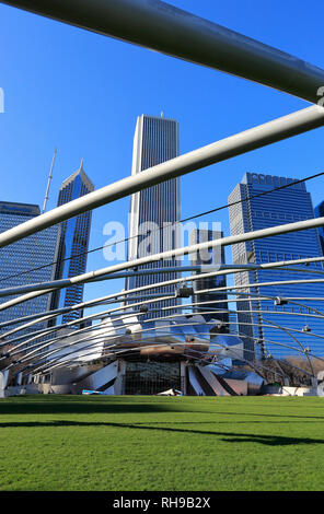 The daytime view of Jay Pritzker Pavilion in Millennium Park with skyscrapers and Chicago's skyline in the background.Chicago.Illinois.USA Stock Photo