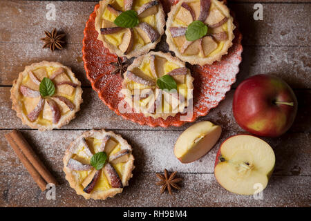 Apple tart and spices on a wooden background Stock Photo