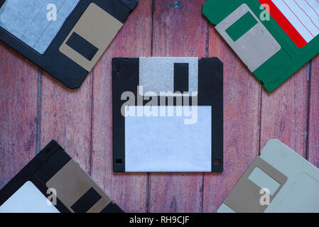Antique pc diskettes on a brown wooden background Stock Photo