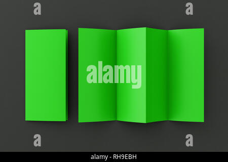 Blank green folded paper leaflet on black background. Eight pages, four panel Stock Photo