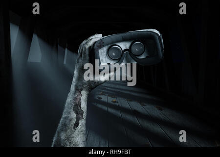 bloody hand holding vr device in front of wooden bridge at night Stock Photo