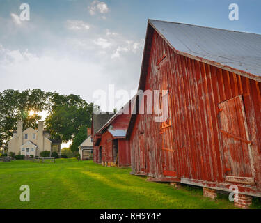 Historic old red barns and a house in afternoon sunlight at Windsor Castle Park in Smithfield,Virginia Stock Photo
