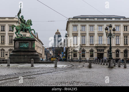 Brussels, Belgium - 02 01 2019: Royal square with statue, tramway rails and the tower of the courthouse in the background during a cold winterday Stock Photo