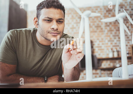 Serious brunette male being deep in thoughts Stock Photo