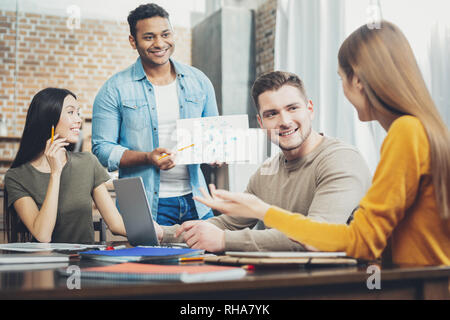 Attractive four students working on project Stock Photo