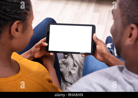 Close-up Of A Couple Holding Digital Tablet With Blank White Screen Stock Photo