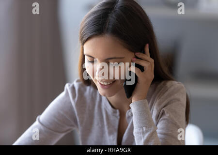 Happy teen girl talking on phone having pleasant mobile conversation Stock Photo