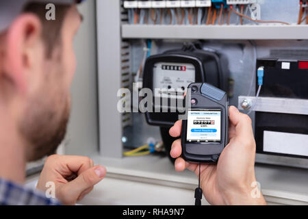 Close-up Of A Male Technician Doing Meter Reading Stock Photo
