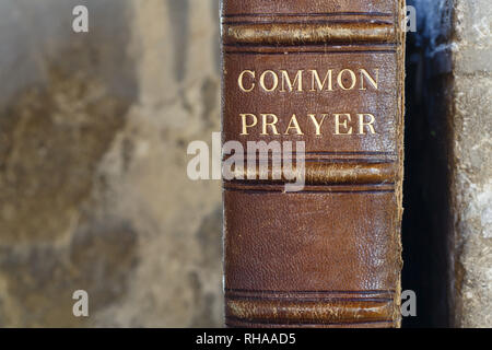Detail of an old leather-bound christian prayer book with a stone background and copy space Stock Photo