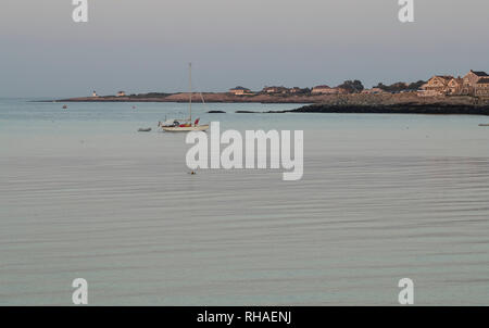 Boat in water, surrounded by water, houses, lighthouse off Bearskin Neck, in Rockport, Massachusetts. Popular summer town on Boston's North Shore. Stock Photo