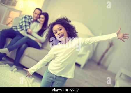 Excited funny kid goofing around in her bedroom. Stock Photo