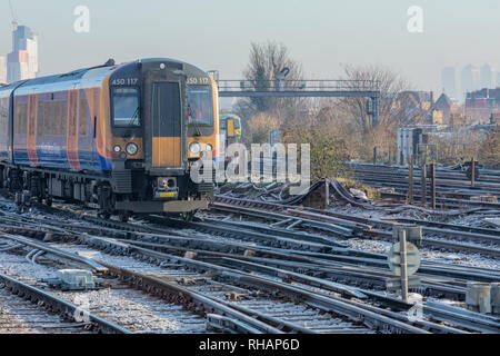 31st January 2019; Clapham Junction, London, UK; Train Approaching Station With Frost Visible on Tracks Stock Photo