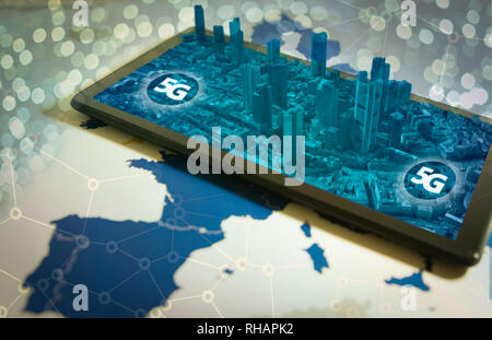Smartphone with 3D city on screen and 5G word Stock Photo