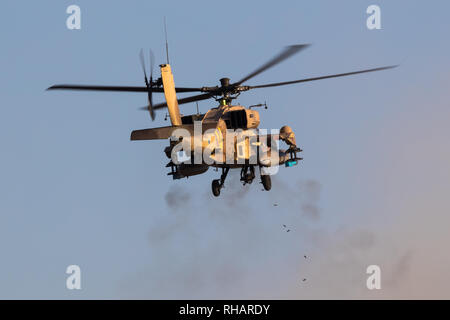 Israeli Air Force AH-64 Apache combat helicopter firing guns during an airshow at Hatzerim, close to Beersheva Israel Stock Photo
