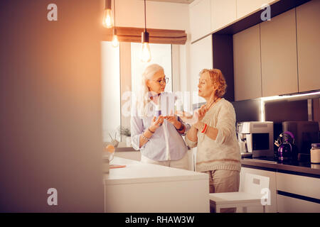 Positive nice women discussing vitamins Stock Photo - Alamy