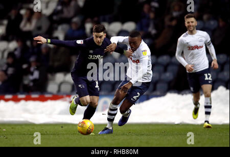 Derby County's Tom Lawrence (left) and Preston North End's Darnell Fisher battle for the ball during the Sky Bet Championship match at Deepdale, Preston. Stock Photo