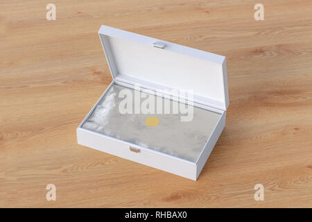 White open long box or casket with wrapping foil on wooden background Stock Photo