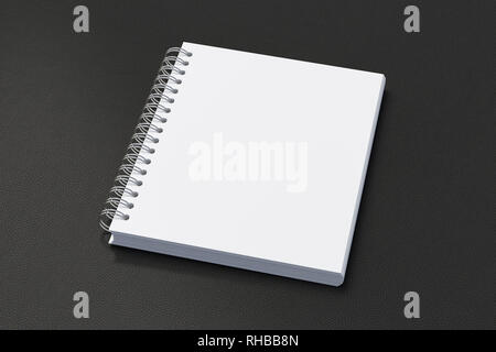 Blank vertical spiral notepad on black background. With clipping path around notebook pages Stock Photo