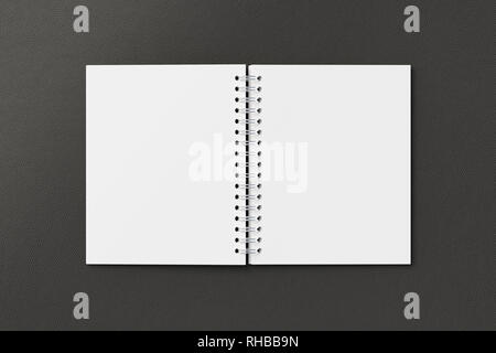 Blank open vertical spiral notepad on black background. With clipping path around notebook pages Stock Photo