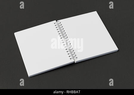 Blank open vertical spiral notepad on black background. With clipping path around notebook pages Stock Photo