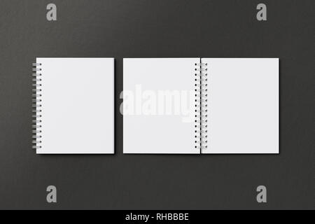 Blank open and closed vertical spiral notepads on black background. With clipping path around notebooks pages Stock Photo