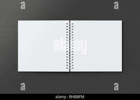 Blank open square spiral notepad on black background. With clipping path around notebook pages Stock Photo