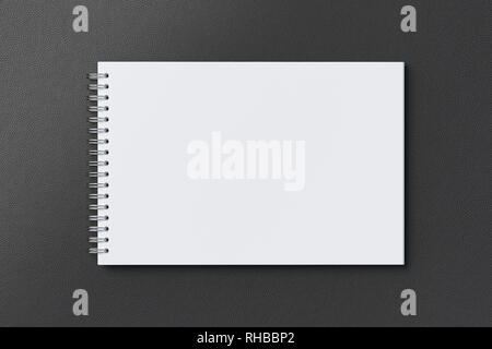 Blank horizontal spiral notepad on black background. With clipping path around notebook pages Stock Photo
