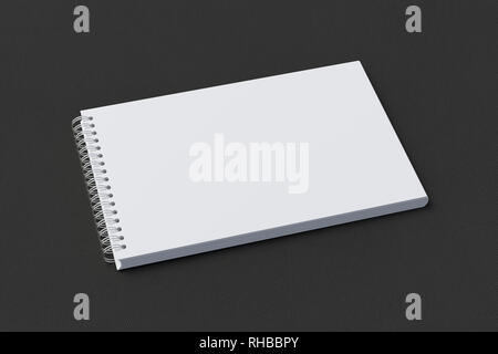 Blank horizontal spiral notepad on black background. With clipping path around notebook pages Stock Photo
