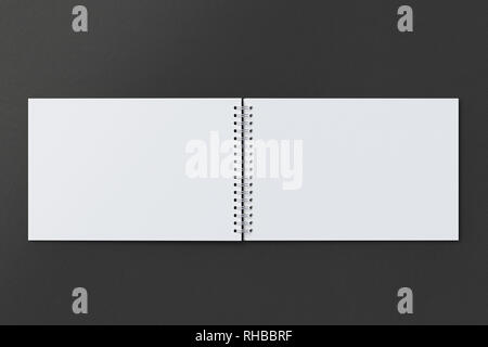 Blank open horizontal spiral notepad on black background. With clipping path around notebook pages Stock Photo