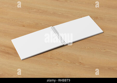 Blank open horizontal spiral notepad on wooden background. With clipping path around notebook pages Stock Photo