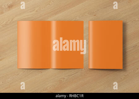 Blank brown open and folded half-folded flyer leaflet on wooden background. With clipping path around brochure Stock Photo