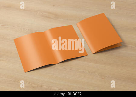 Blank brown open and folded half-folded flyer leaflet on wooden background. With clipping path around brochure Stock Photo