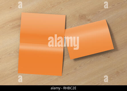Blank brown open and folded half-folded flyer leaflet on wooden background. With clipping path around brochure Stock Photo