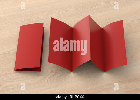 Blank red folded paper leaflet on wooden background. Eight pages, four panel Stock Photo
