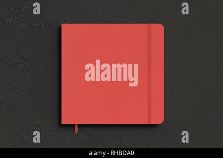 Red square notebook with elastic band on black background Stock Photo