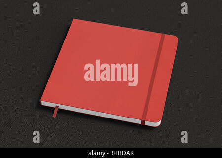Red square notebook with elastic band on black background Stock Photo