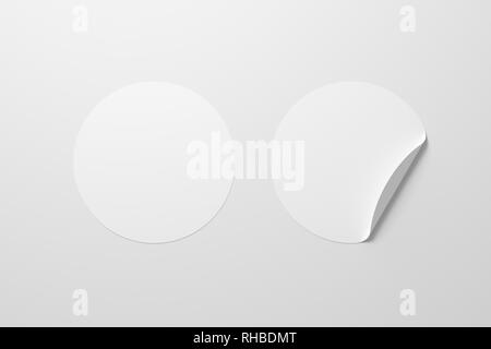 Blank white round stickers straightened and with folded corner on white background. With clipping path around stickers. Stock Photo