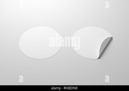 Blank white round stickers straightened and with folded corner on white background. With clipping path around stickers. Stock Photo