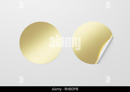 Blank golden round stickers straightened and with folded corner on white background. With clipping path around stickers. Stock Photo